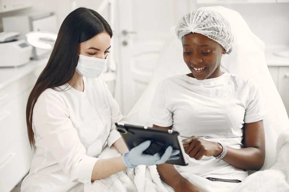 Dermatology clinician and patient reviewing a personalized laser treatment plan