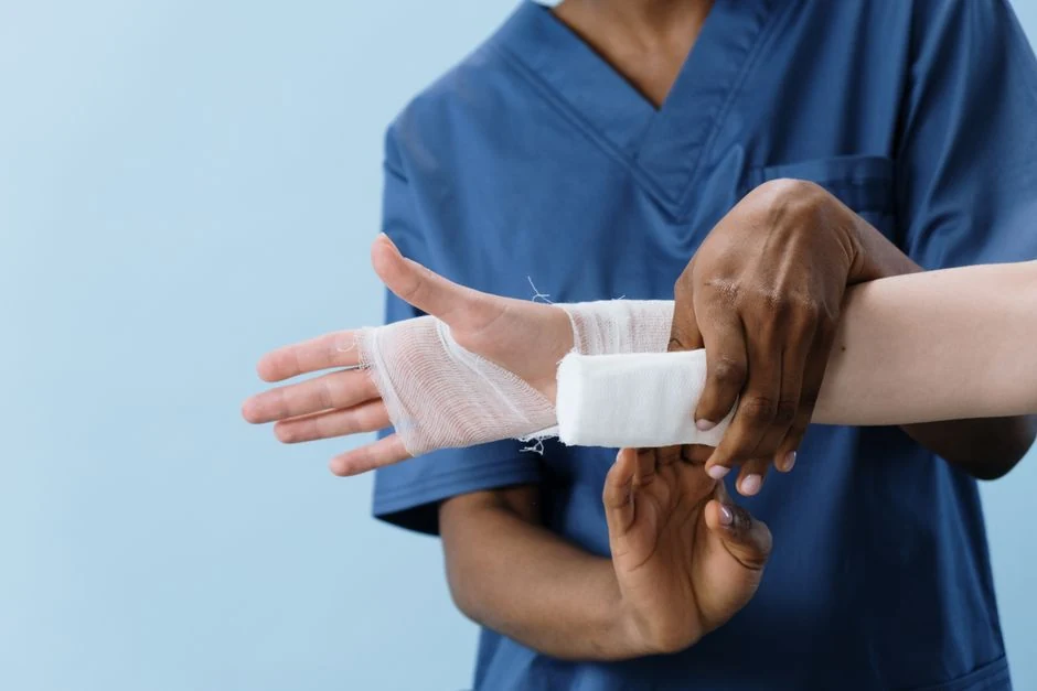 Medical professional applying a clean bandage during office aftercare