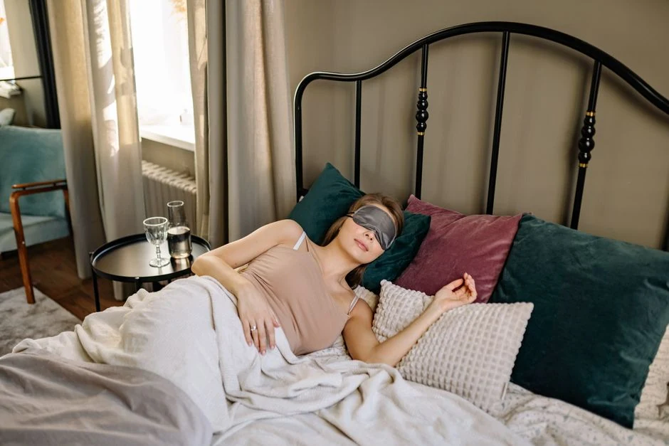 Woman resting comfortably with a sleep mask during planned recovery time